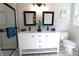 Updated bathroom features a modern double vanity, shower, and decorative tile floor at 2110 E Cherokee Dr, Woodstock, GA 30188