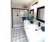 Bathroom with black framed shower and double sink vanity with modern tile flooring at 2110 E Cherokee Dr, Woodstock, GA 30188