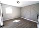 Bedroom with geometric accent wall, hardwood floors, and natural light at 2110 E Cherokee Dr, Woodstock, GA 30188