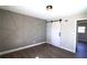 Stylish bedroom features geometric accent wall, wood floors, and sliding barn door at 2110 E Cherokee Dr, Woodstock, GA 30188