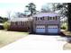 Beautiful home featuring a brick facade, wood shutters, large porch, and a two-car garage at 2110 E Cherokee Dr, Woodstock, GA 30188