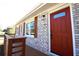 This home features a charming front door, stylish shutters, and a lovely front porch at 2110 E Cherokee Dr, Woodstock, GA 30188