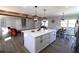 Open concept kitchen with large island, modern lighting fixtures, and hardwood floors at 2110 E Cherokee Dr, Woodstock, GA 30188