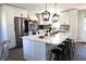 Well-equipped kitchen with a central island, stainless steel refrigerator, and modern pendant lighting at 2110 E Cherokee Dr, Woodstock, GA 30188
