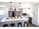 Bright kitchen with white cabinets, stainless steel appliances, and large island with seating at 2110 E Cherokee Dr, Woodstock, GA 30188