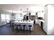 Open-concept kitchen features white cabinets, a large island, and stainless steel appliances at 2110 E Cherokee Dr, Woodstock, GA 30188