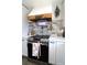 Close up of a kitchen area with stainless steel oven, backsplash, and custom wood range hood at 2110 E Cherokee Dr, Woodstock, GA 30188