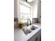 Modern kitchen sink with stainless steel faucet, quartz countertop, and natural light at 2110 E Cherokee Dr, Woodstock, GA 30188
