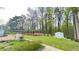 Expansive backyard with garden beds, mature trees, shed, and a well-manicured lawn offering outdoor space at 4083 Rivermeade Sw Dr, Lilburn, GA 30047