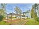 Large backyard featuring raised garden beds, mature trees, and a lush lawn providing a private outdoor space at 4083 Rivermeade Sw Dr, Lilburn, GA 30047