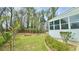 Spacious backyard with well-maintained lawn, a patio, garden beds, and mature trees for shade and privacy at 4083 Rivermeade Sw Dr, Lilburn, GA 30047