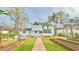 View of the home's backyard with garden beds and a brick walkway leading to the back of the home at 4083 Rivermeade Sw Dr, Lilburn, GA 30047