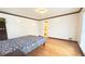 Bedroom with hardwood floors and view into bathroom at 4083 Rivermeade Sw Dr, Lilburn, GA 30047