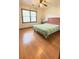 Bedroom with hardwood floors, ceiling fan, and a large window for natural light at 4083 Rivermeade Sw Dr, Lilburn, GA 30047