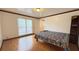 Bright bedroom with a large window, hardwood floors, and closet space at 4083 Rivermeade Sw Dr, Lilburn, GA 30047