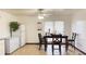 Bright dining room featuring a ceiling fan, tile floor, and adjacent refrigerator and freezer at 4083 Rivermeade Sw Dr, Lilburn, GA 30047