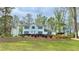 Charming two-story home with blue shutters, lush landscaping, and a well-maintained front lawn at 4083 Rivermeade Sw Dr, Lilburn, GA 30047