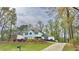 Inviting two-story home with blue shutters, a neatly terraced front yard, and a driveway at 4083 Rivermeade Sw Dr, Lilburn, GA 30047