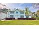 Charming two-story home featuring blue shutters, a well-maintained lawn, and beautiful landscaping at 4083 Rivermeade Sw Dr, Lilburn, GA 30047