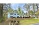Inviting two-story home with blue shutters, attractive landscaping, and a neatly terraced front yard at 4083 Rivermeade Sw Dr, Lilburn, GA 30047
