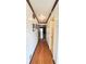 Hallway featuring gleaming hardwood floors and decorative lighting at 4083 Rivermeade Sw Dr, Lilburn, GA 30047