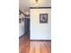 Hallway featuring gleaming hardwood floors and decorative lighting at 4083 Rivermeade Sw Dr, Lilburn, GA 30047
