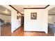Hallway featuring gleaming hardwood floors and view into multiple rooms at 4083 Rivermeade Sw Dr, Lilburn, GA 30047