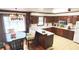 Well-appointed kitchen with wooden cabinets, and a dining area with great natural light at 4083 Rivermeade Sw Dr, Lilburn, GA 30047