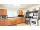 The kitchen features wooden cabinets and stainless steel appliances, creating a modern cooking space at 4083 Rivermeade Sw Dr, Lilburn, GA 30047
