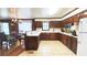 Spacious kitchen with wood cabinets, and a connecting dining area at 4083 Rivermeade Sw Dr, Lilburn, GA 30047