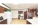 Kitchen featuring tiled floors, wood cabinets, and a built in desk area at 4083 Rivermeade Sw Dr, Lilburn, GA 30047