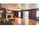 Elegant living room featuring hardwood floors, fireplace, custom built-ins, and a ceiling fan at 4083 Rivermeade Sw Dr, Lilburn, GA 30047