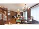 Dining and living area featuring hardwood floors, a fireplace, and elegant chandelier at 4083 Rivermeade Sw Dr, Lilburn, GA 30047