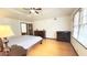 The main bedroom features a ceiling fan and abundant natural light from multiple windows at 4083 Rivermeade Sw Dr, Lilburn, GA 30047