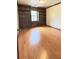 Office space with hardwood floors, built-in bookshelves, and natural light at 4083 Rivermeade Sw Dr, Lilburn, GA 30047