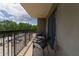 Cozy balcony with seating, offering a view of the surrounding trees and parking area at 795 Hammond Dr # 407, Sandy Springs, GA 30328