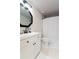 Modern bathroom features a white vanity, sleek black fixtures, and a shower with a white curtain at 795 Hammond Dr # 407, Sandy Springs, GA 30328