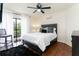 Cozy bedroom features a queen bed with white linens, ceiling fan, and balcony access at 795 Hammond Dr # 407, Sandy Springs, GA 30328