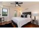 Comfortable bedroom boasts a queen bed, ceiling fan, and balcony access, plus stylish decor at 795 Hammond Dr # 407, Sandy Springs, GA 30328