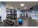 Bright gym with an assortment of free weights, exercise machines, and a mirrored wall at 795 Hammond Dr # 407, Sandy Springs, GA 30328