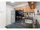 Modern kitchen with stainless steel appliances, granite countertops, and a sleek, functional design at 795 Hammond Dr # 407, Sandy Springs, GA 30328