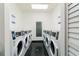Functional laundry room with multiple white, front-loading washing machines lining both walls at 795 Hammond Dr # 407, Sandy Springs, GA 30328
