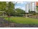 Well maintained community lawn with black metal decorative fencing, walking path, and mature shade trees at 795 Hammond Dr # 407, Sandy Springs, GA 30328