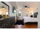 Serene main bedroom features a queen bed, ceiling fan, dark wood floors, and a balcony with a view at 795 Hammond Dr # 407, Sandy Springs, GA 30328