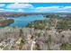 Aerial view of a home showcasing its proximity to a beautiful lake surrounded by lush forest at 2715 Brook Valley Dr, Cumming, GA 30041