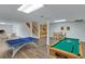 Entertainment basement features a pool table, ping pong table, and a staircase at 2715 Brook Valley Dr, Cumming, GA 30041
