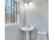 The newly remodeled bathroom has a modern sink and stylish fixtures and beautiful tile at 2715 Brook Valley Dr, Cumming, GA 30041