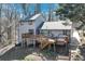 Charming home exterior features a large deck, patio, and a beautiful wooded lot at 2715 Brook Valley Dr, Cumming, GA 30041