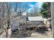 Charming back of home with a large deck, a lower level patio, and luscious tree coverage at 2715 Brook Valley Dr, Cumming, GA 30041