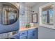Bright laundry area with blue cabinets, butcher block counters, window view, and modern appliances at 2715 Brook Valley Dr, Cumming, GA 30041